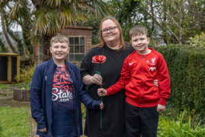 Amy Olsen and her sons Max and Theo holding their Remember Me Rose